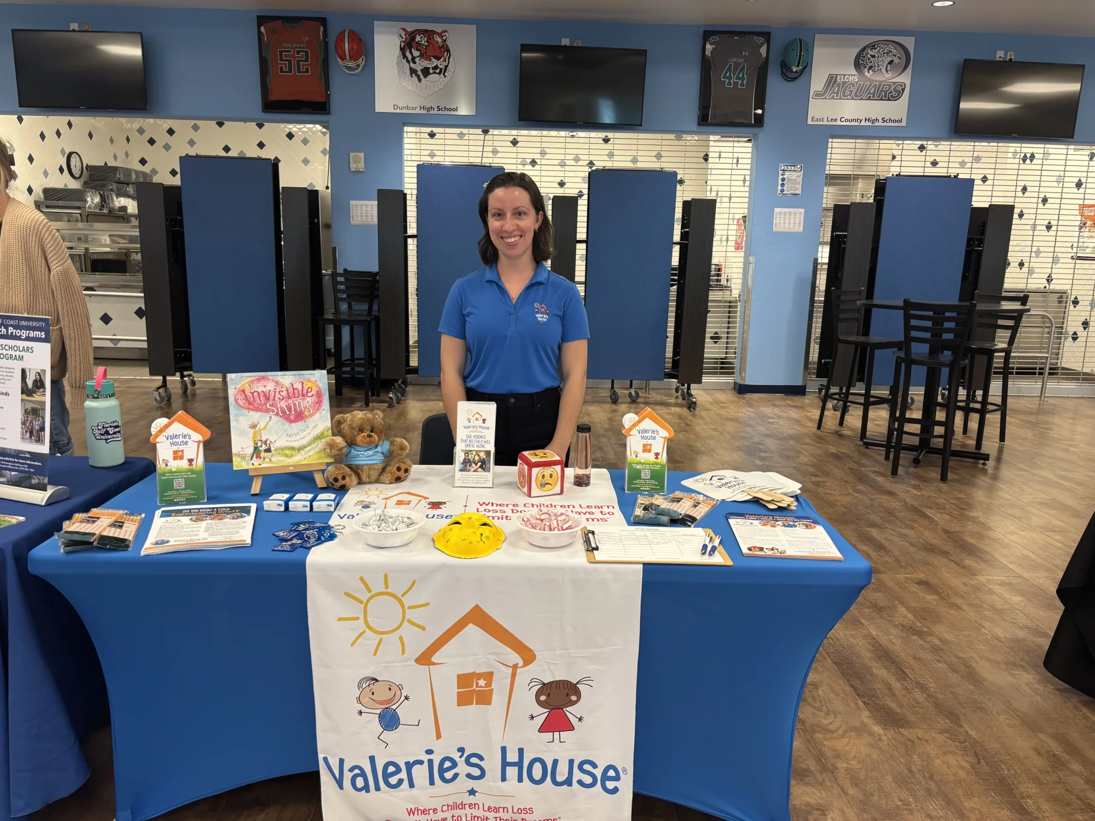 Woman smiling at Valeries House Booth