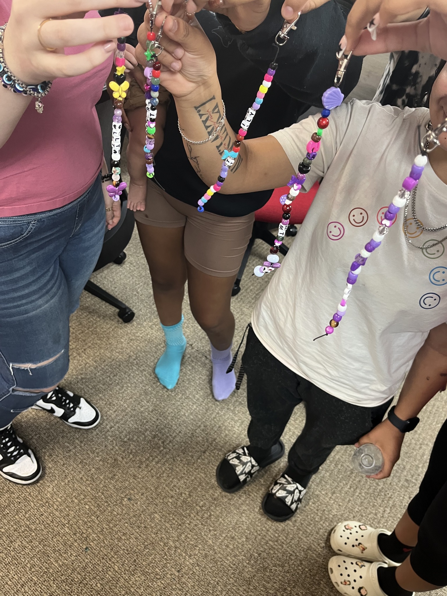 Students holding handmade beaded keychains during a Valerie’s House school group