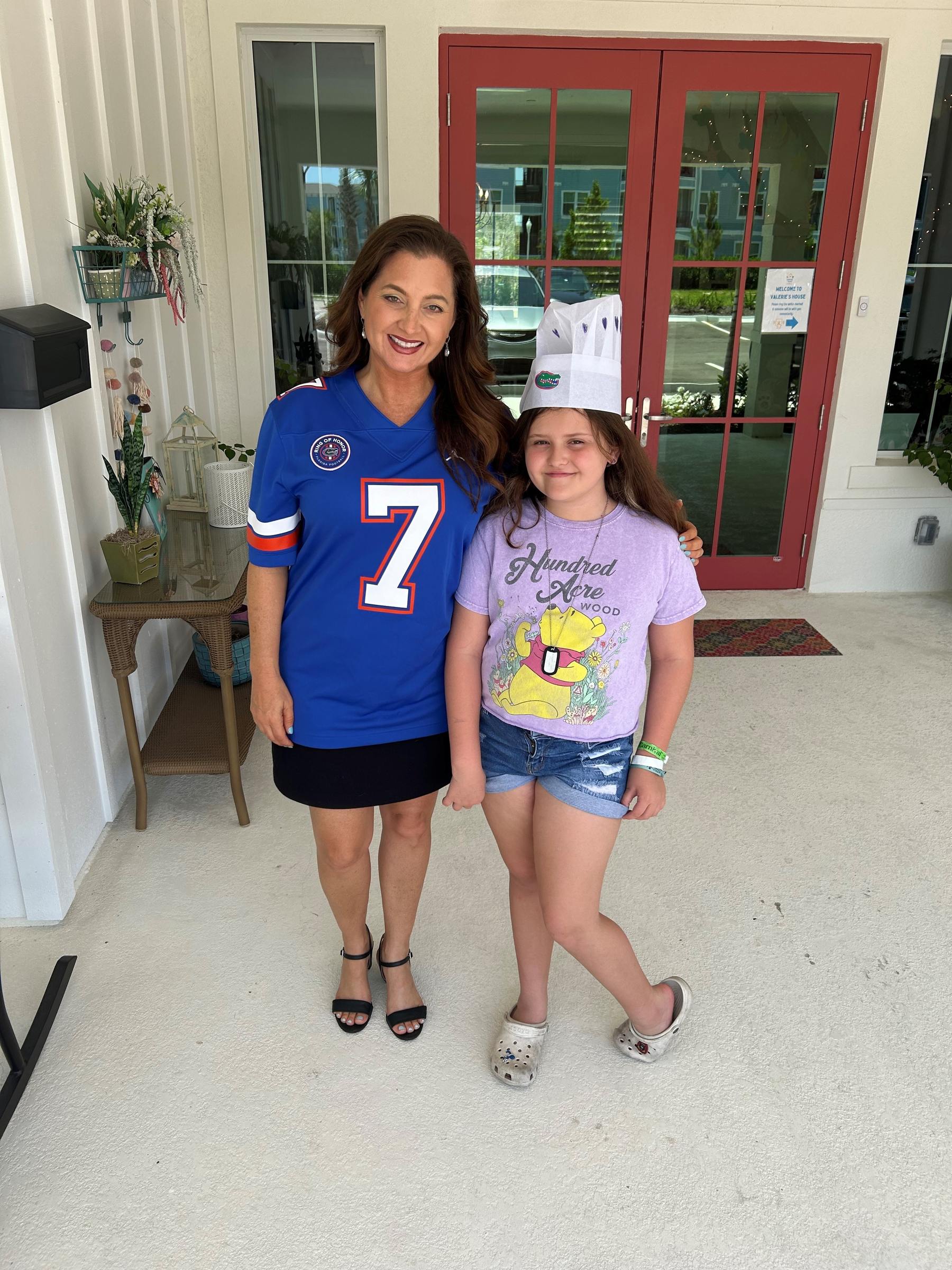 Valerie’s House Founder and CEO Angela Melvin stands with Kinzley outside the Fort Myers Family is Forever Home.