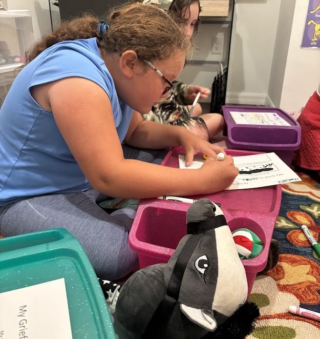 Kids working on a grief activity during group night at Valerie’s House