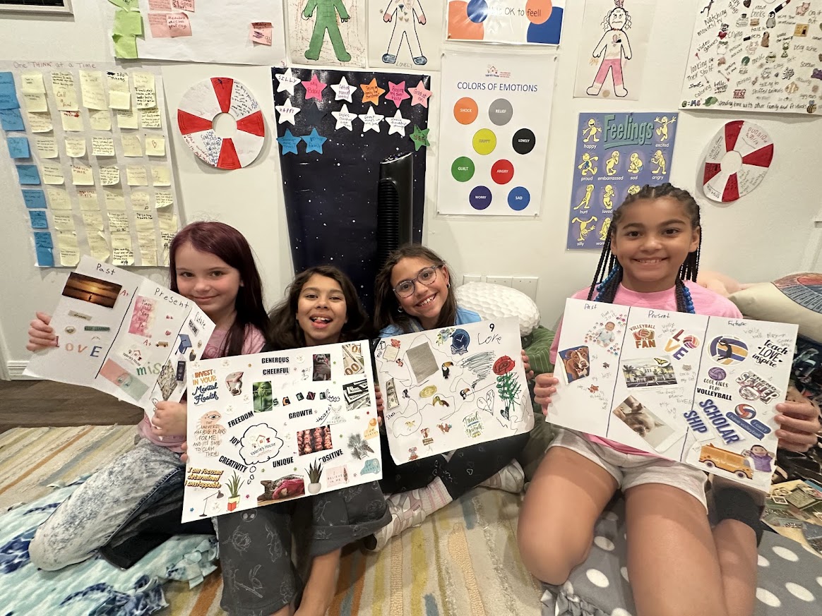 Kids holding artwork created during a group night at Valerie’s House