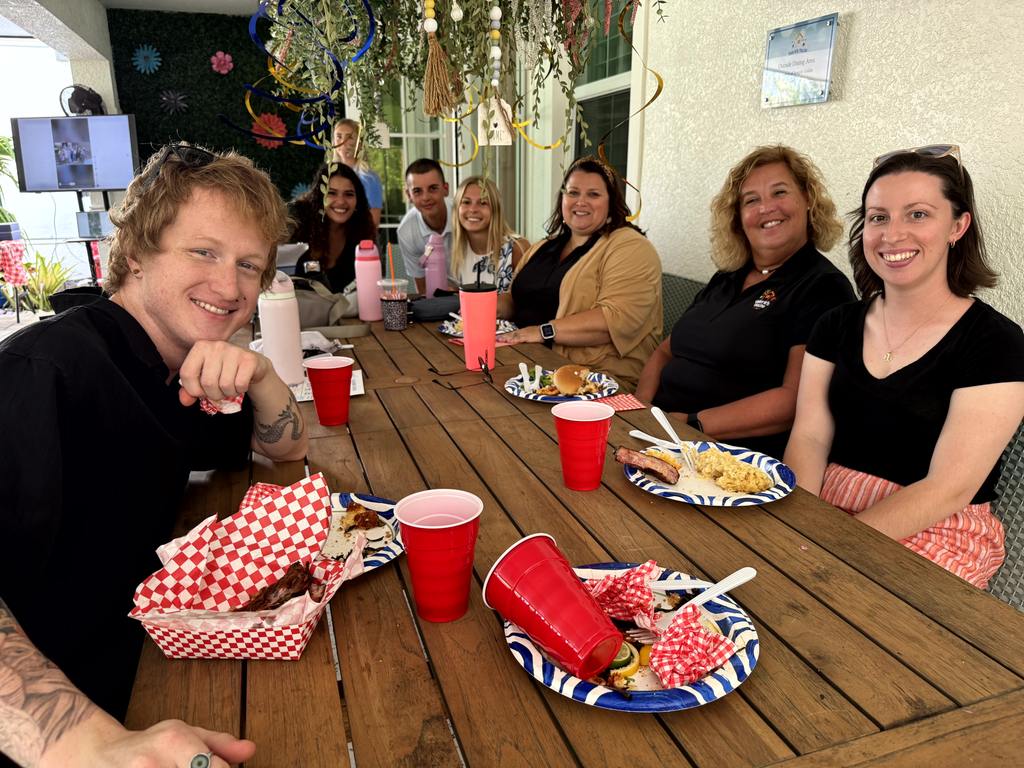 Volunteers seated together sharing a meal at Valerie’s House Volunteer Appreciation Day in Fort Myers