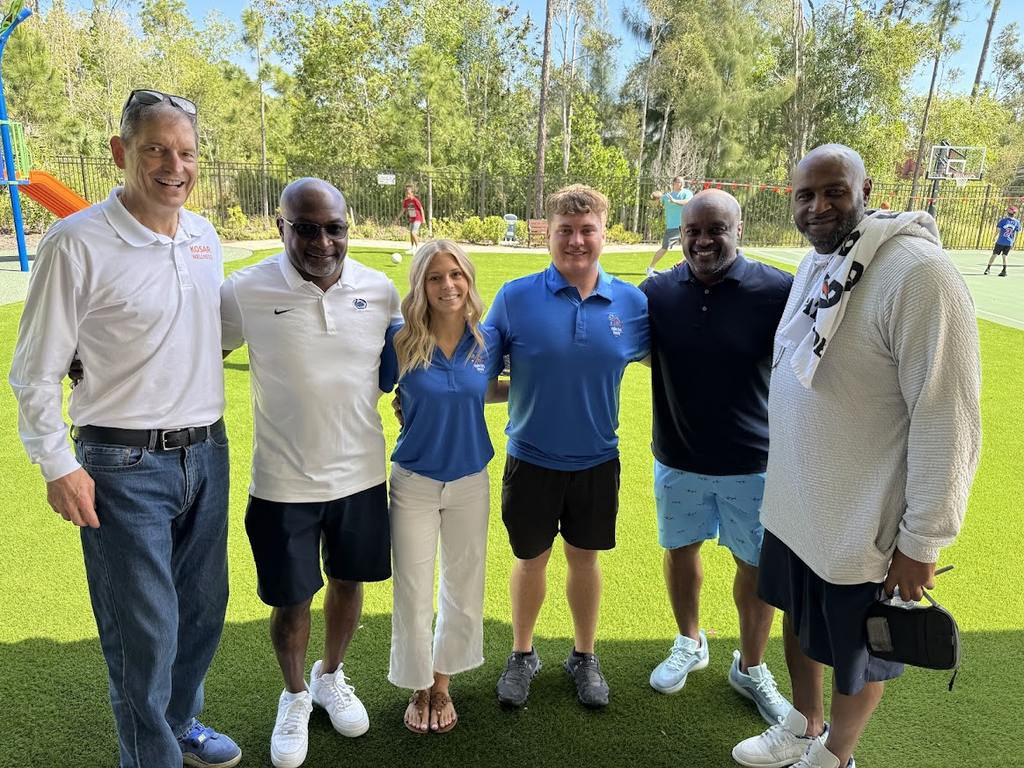 Champions for Children athletes and Valerie’s House staff standing together outside at the Fort Myers Family is Forever Home during a visit with grieving kids