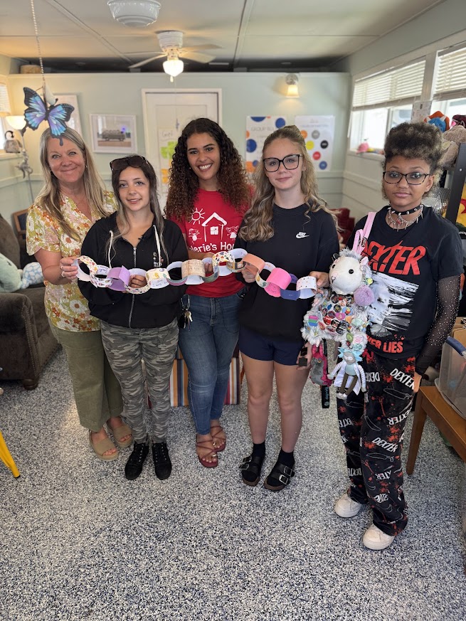 Kids and staff holding a paper chain activity at Valerie’s House