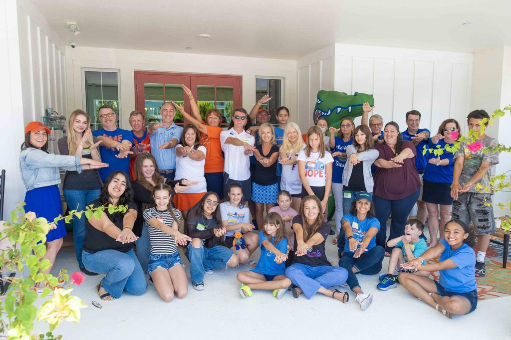 SWFL Gator Club volunteers and Valerie’s House families celebrate International Gator Day at the Fort Myers Family is Forever Home.