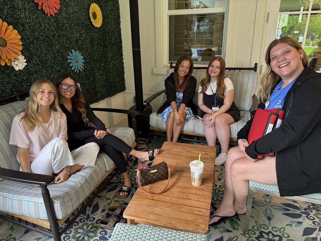 Valerie’s House Teen Ambassadors smile together on the porch.