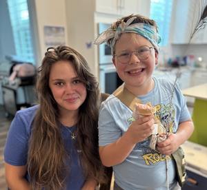 Teen Ambassador Myah smiles with Carter, an elementary-aged child in the Valerie’s House program.