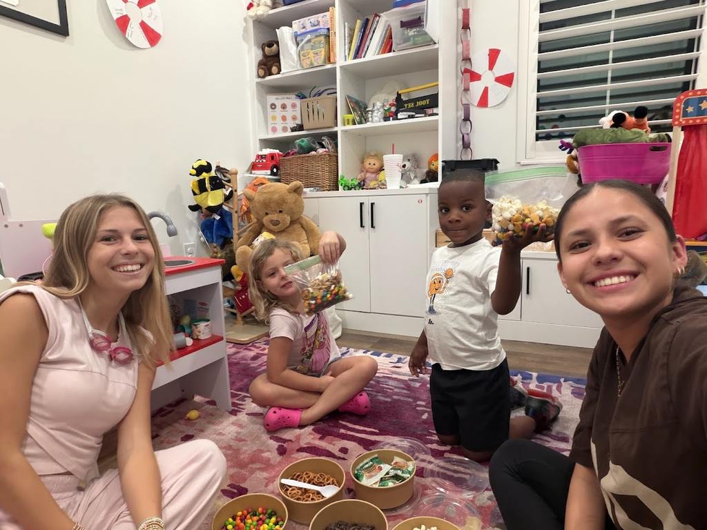 Briza smiles with kids during a Valerie’s House Minnows group activity.