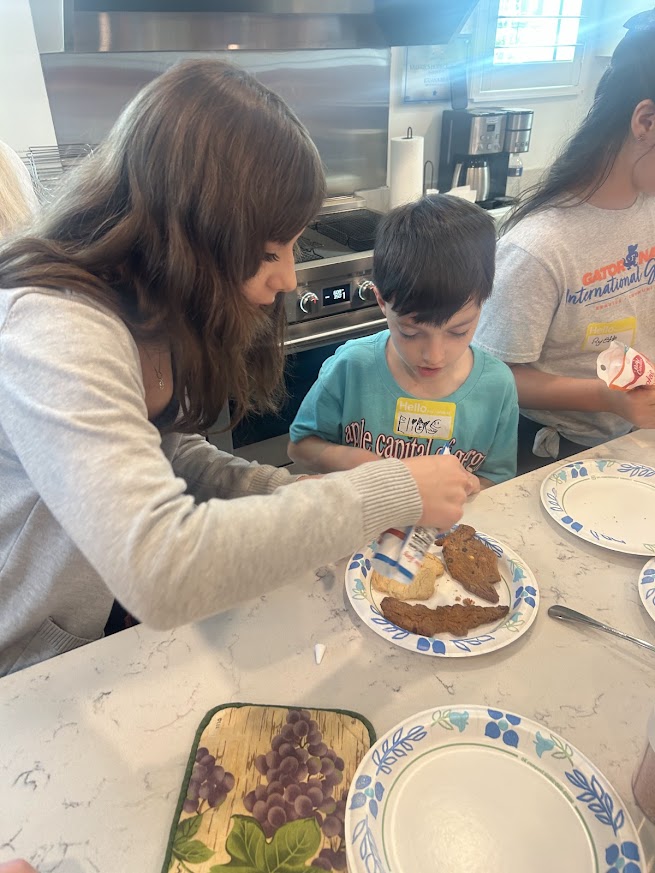 SWFL Gator Club volunteers and Valerie’s House families celebrate International Gator Day at the Fort Myers Family is Forever Home.