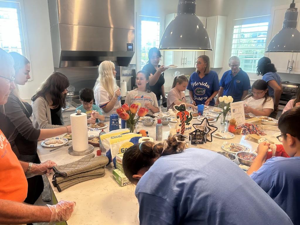 SWFL Gator Club volunteers and Valerie’s House families celebrate International Gator Day at the Fort Myers Family is Forever Home.