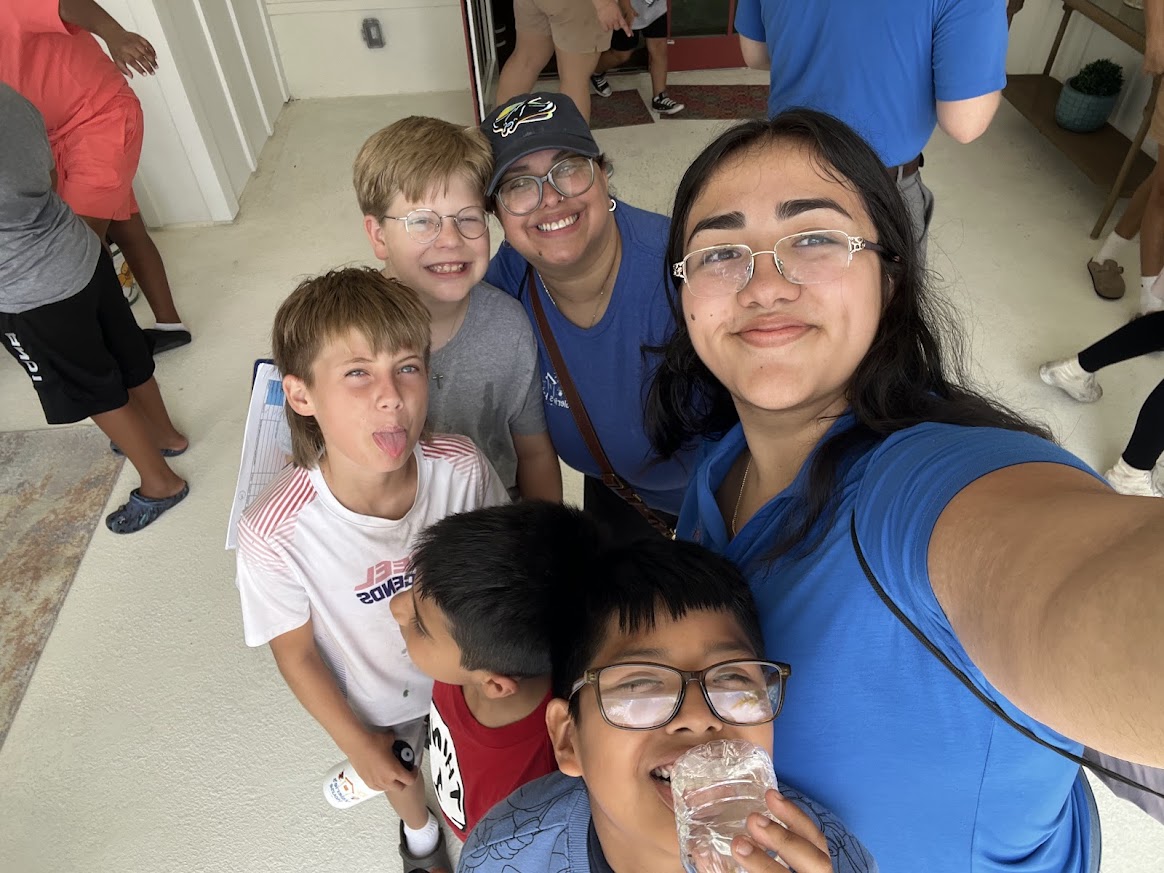 Valerie’s House Teen Ambassador Emely Calderon takes a selfie with kids during summer camp at the Fort Myers Family is Forever Home.
